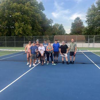 Adult group tennis lesson on outdoor courts in Indianapolis